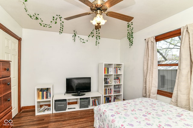 bedroom with baseboards, ceiling fan, and wood finished floors