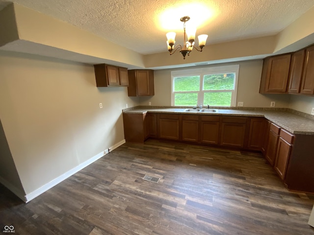 1019 E Jackson St, Shelbyville, IN 46176 - kitchen with brown cabinets, a sink, a textured ceiling, visible vents, and dark wood-style floors