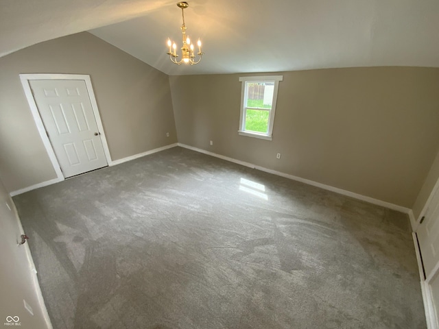 1019 E Jackson St, Shelbyville, IN 46176 - carpeted empty room featuring baseboards, lofted ceiling, and a notable chandelier
