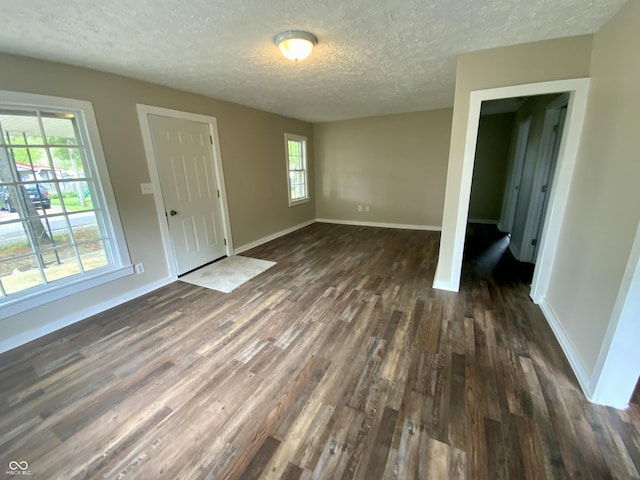 1019 E Jackson St, Shelbyville, IN 46176 - interior space with dark wood-style flooring, a textured ceiling, and baseboards