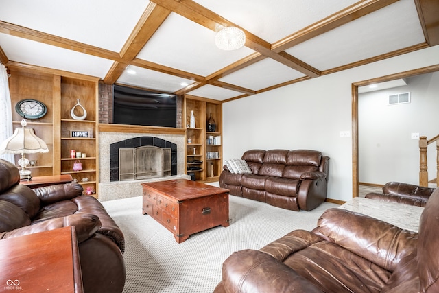 carpeted living room featuring visible vents, a large fireplace, built in shelves, baseboards, and coffered ceiling