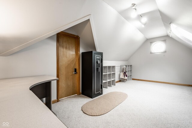 additional living space featuring baseboards, lofted ceiling, and carpet