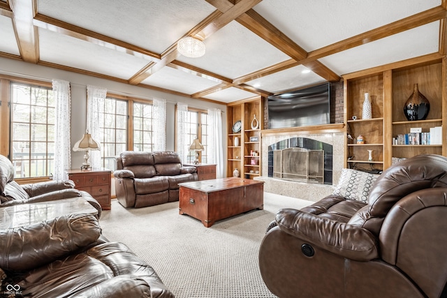carpeted living area featuring beamed ceiling, a fireplace with raised hearth, coffered ceiling, and built in shelves