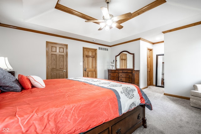 bedroom with light colored carpet, baseboards, a tray ceiling, visible vents, and ornamental molding