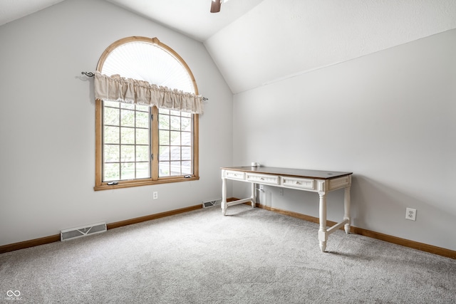 unfurnished office featuring ceiling fan, carpet floors, baseboards, lofted ceiling, and visible vents