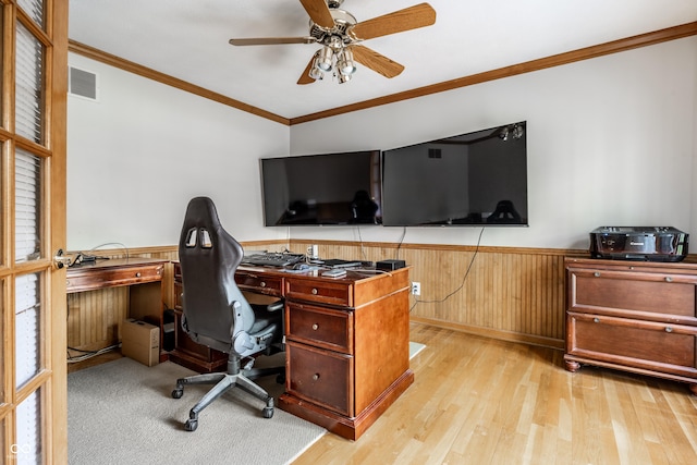 office area with visible vents, ornamental molding, wainscoting, ceiling fan, and light wood finished floors