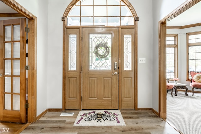 entrance foyer featuring baseboards, visible vents, and light wood-style floors
