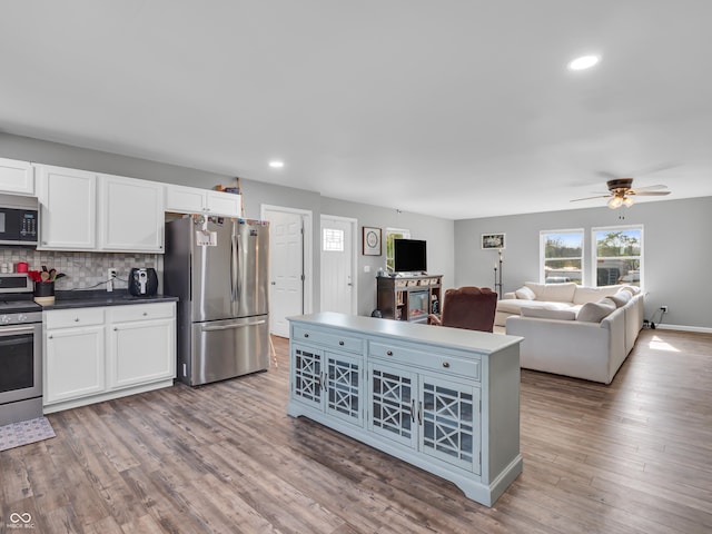 kitchen featuring appliances with stainless steel finishes, white cabinetry, ceiling fan, and backsplash