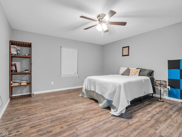bedroom with wood finished floors and baseboards