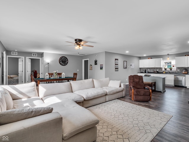 living room with dark wood-style floors, recessed lighting, ceiling fan, visible vents, and baseboards