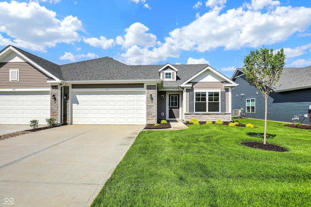 110 Maxim Ct, Cumberland, IN 46229 - view of front facade featuring stone siding, a front yard, a shingled roof, an attached garage, and driveway