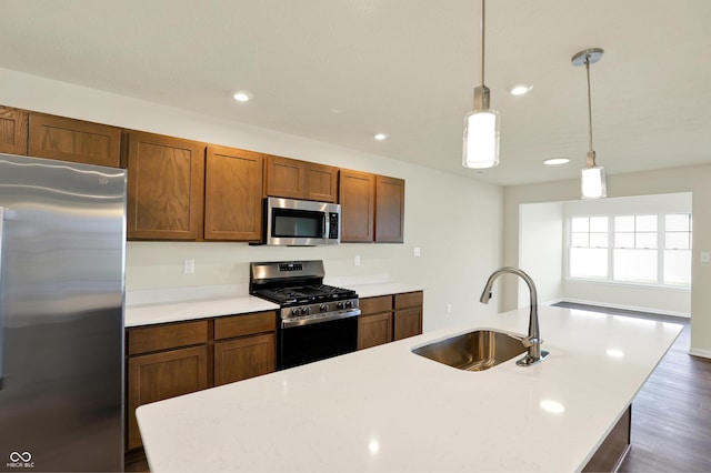 110 Maxim Ct, Cumberland, IN 46229 - kitchen with decorative light fixtures, appliances with stainless steel finishes, a sink, light countertops, and recessed lighting