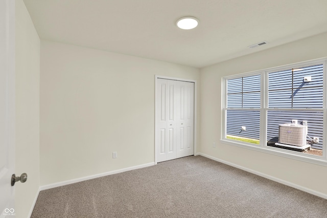 110 Maxim Ct, Cumberland, IN 46229 - unfurnished bedroom with baseboards, carpet, visible vents, and a closet