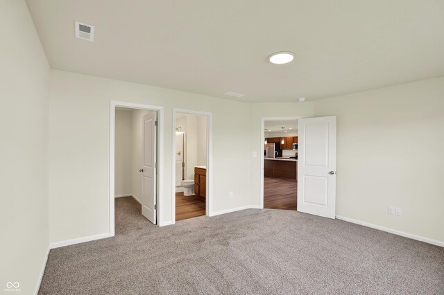 110 Maxim Ct, Cumberland, IN 46229 - unfurnished bedroom with carpet floors, stainless steel refrigerator with ice dispenser, and baseboards