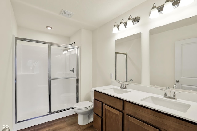 110 Maxim Ct, Cumberland, IN 46229 - bathroom with a sink, wood finished floors, toilet, and a shower stall
