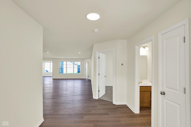 110 Maxim Ct, Cumberland, IN 46229 - corridor featuring recessed lighting, baseboards, dark wood finished floors, and a sink