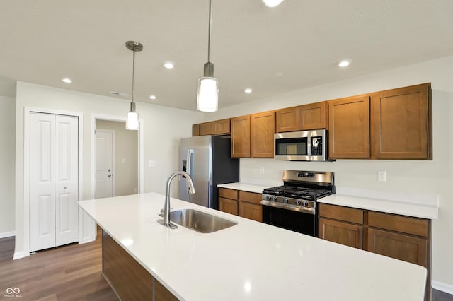 110 Maxim Ct, Cumberland, IN 46229 - kitchen with brown cabinets, a sink, light countertops, stainless steel appliances, and dark wood-type flooring