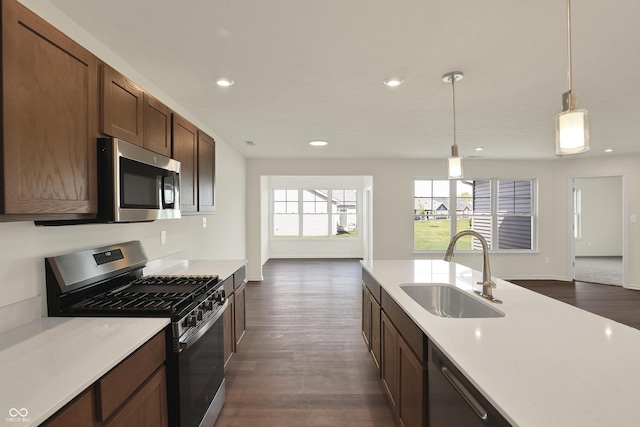 110 Maxim Ct, Cumberland, IN 46229 - kitchen with a sink, light countertops, stainless steel appliances, open floor plan, and dark wood-style floors