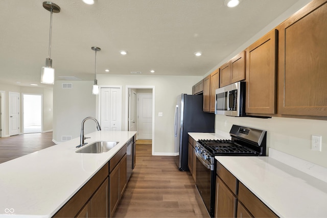 110 Maxim Ct, Cumberland, IN 46229 - kitchen featuring a sink, light countertops, stainless steel appliances, and dark wood-type flooring