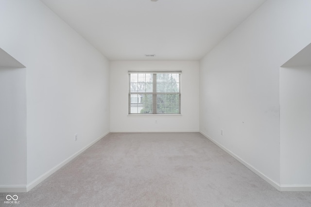 carpeted empty room with baseboards and visible vents