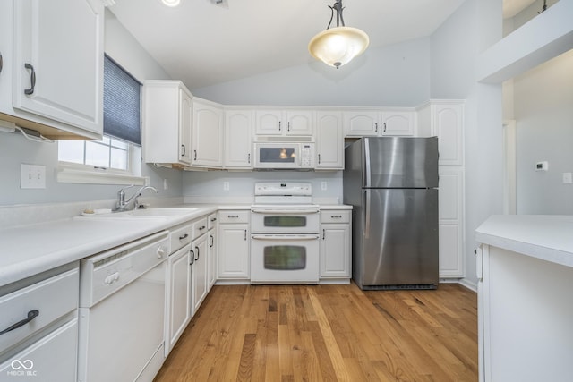 kitchen featuring white cabinets, light wood finished floors, vaulted ceiling, and white appliances