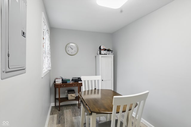 842 Miller Ave, Shelbyville, IN 46176 - dining room with baseboards, electric panel, and wood finished floors