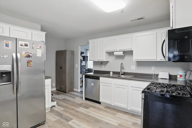 842 Miller Ave, Shelbyville, IN 46176 - kitchen with visible vents, appliances with stainless steel finishes, white cabinetry, a sink, and light wood-style flooring