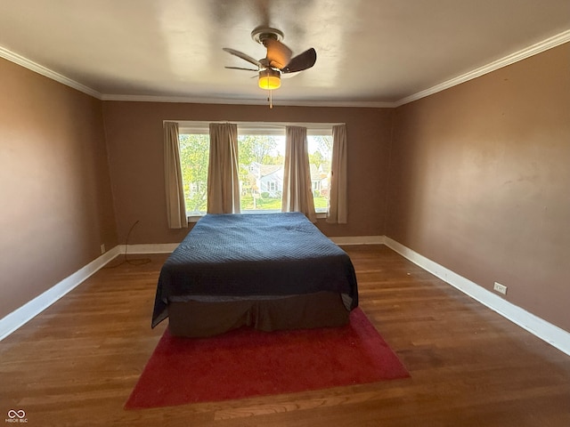 bedroom with baseboards, crown molding, and multiple windows