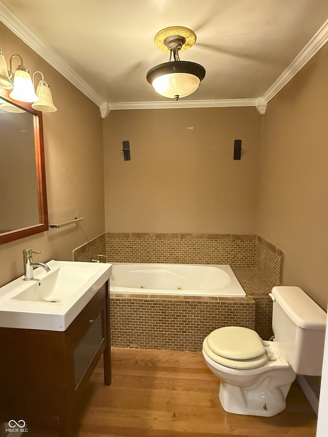 bathroom featuring vanity, toilet, crown molding, a jetted tub, and wood finished floors
