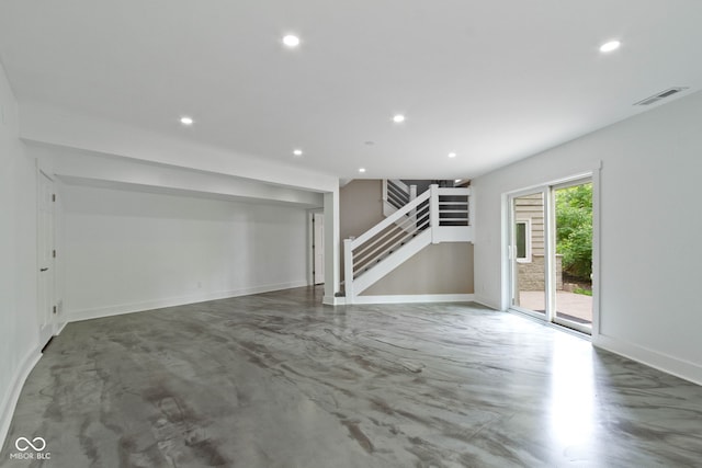 10919 Running Tide Ct, Indianapolis, IN 46236 - unfurnished living room with finished concrete flooring, stairs, recessed lighting, and baseboards