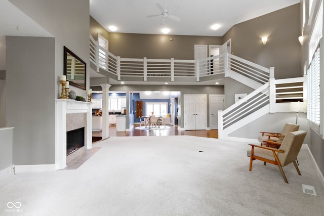 10919 Running Tide Ct, Indianapolis, IN 46236 - living area with a high ceiling, ceiling fan, stairs, a fireplace, and baseboards
