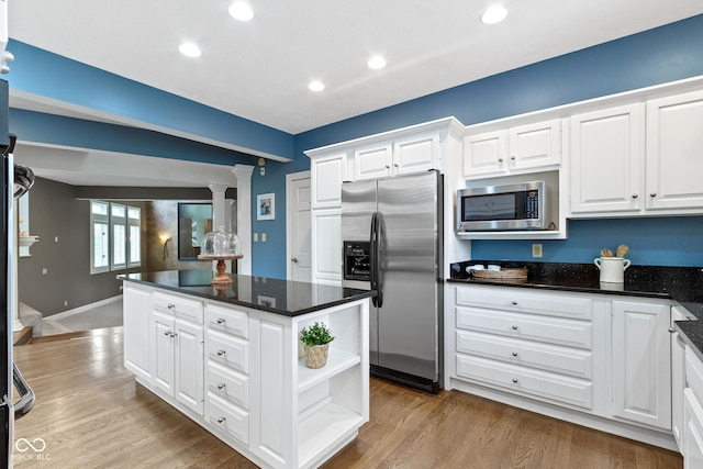 10919 Running Tide Ct, Indianapolis, IN 46236 - kitchen featuring appliances with stainless steel finishes, a center island, white cabinetry, decorative columns, and wood finished floors