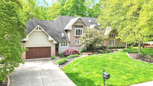 10919 Running Tide Ct, Indianapolis, IN 46236 - view of front of home featuring driveway, brick siding, a front yard, a garage, and roof with shingles