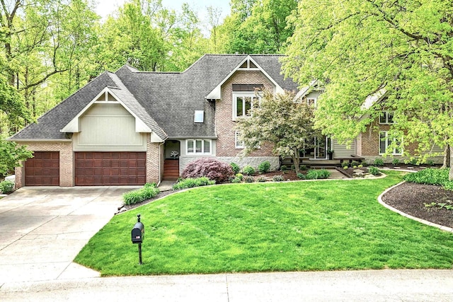 10919 Running Tide Ct, Indianapolis, IN 46236 - view of front facade with brick siding, a front lawn, driveway, an attached garage, and roof with shingles