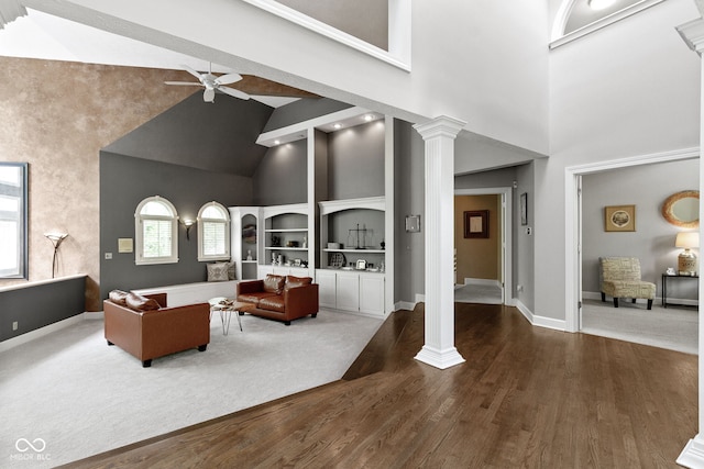 10919 Running Tide Ct, Indianapolis, IN 46236 - living area featuring high vaulted ceiling, decorative columns, ceiling fan, dark wood-style floors, and baseboards