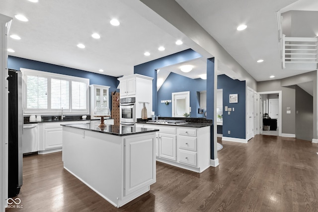 10919 Running Tide Ct, Indianapolis, IN 46236 - kitchen featuring dark countertops, a sink, white cabinetry, a kitchen island, and recessed lighting