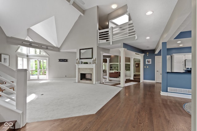 10919 Running Tide Ct, Indianapolis, IN 46236 - unfurnished living room with stairway, high vaulted ceiling, baseboards, a high end fireplace, and recessed lighting