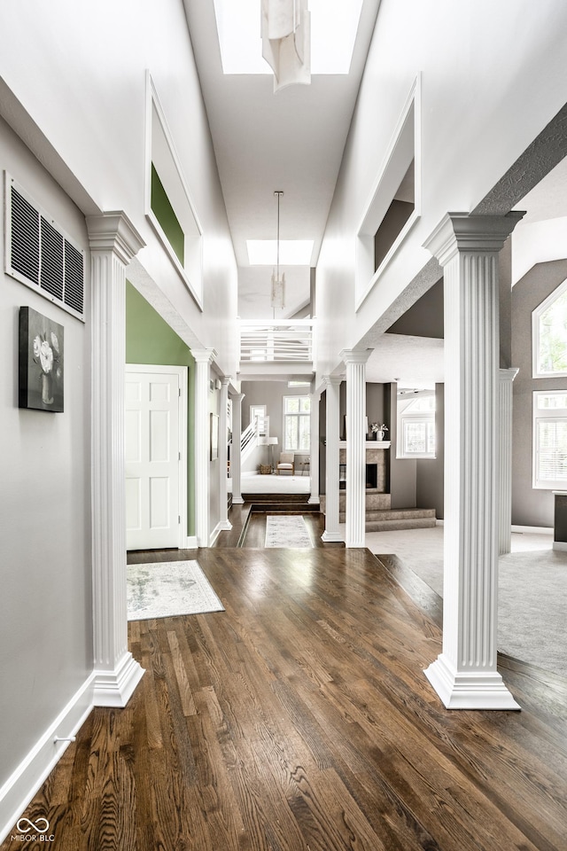 10919 Running Tide Ct, Indianapolis, IN 46236 - hallway with decorative columns, plenty of natural light, and wood finished floors