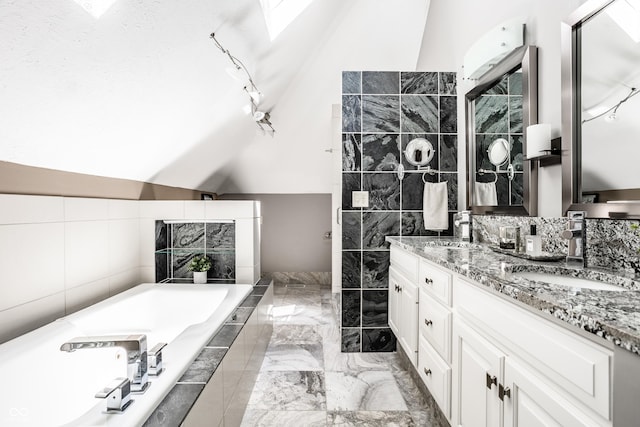 10919 Running Tide Ct, Indianapolis, IN 46236 - full bath featuring double vanity, a garden tub, vaulted ceiling, tile walls, and marble tiled floors