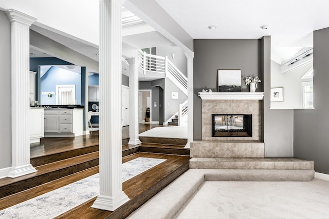 10919 Running Tide Ct, Indianapolis, IN 46236 - living room featuring ornate columns, dark wood finished floors, stairs, and a multi sided fireplace