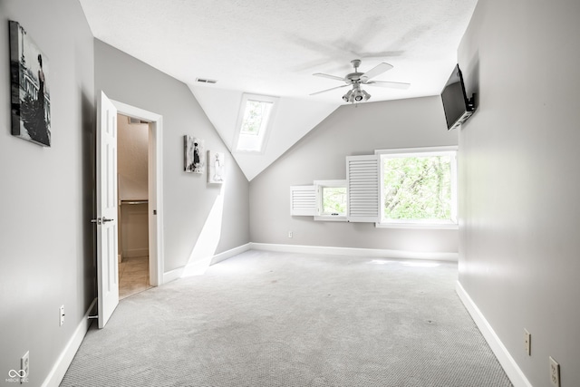 10919 Running Tide Ct, Indianapolis, IN 46236 - unfurnished living room with carpet, a skylight, a ceiling fan, and lofted ceiling
