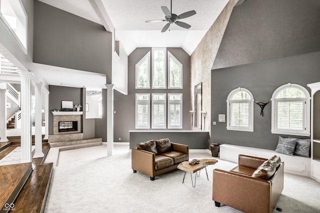 10919 Running Tide Ct, Indianapolis, IN 46236 - living room with decorative columns, a tiled fireplace, carpet floors, ceiling fan, and high vaulted ceiling