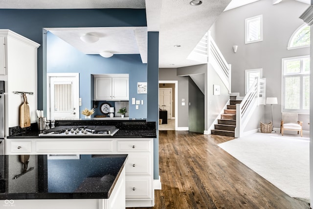 10919 Running Tide Ct, Indianapolis, IN 46236 - kitchen featuring stainless steel gas cooktop, dark wood-style floors, white cabinets, and a textured ceiling