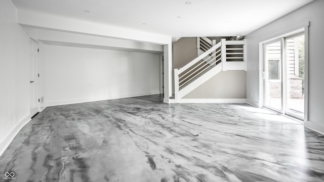 10919 Running Tide Ct, Indianapolis, IN 46236 - unfurnished living room featuring stairway and finished concrete floors