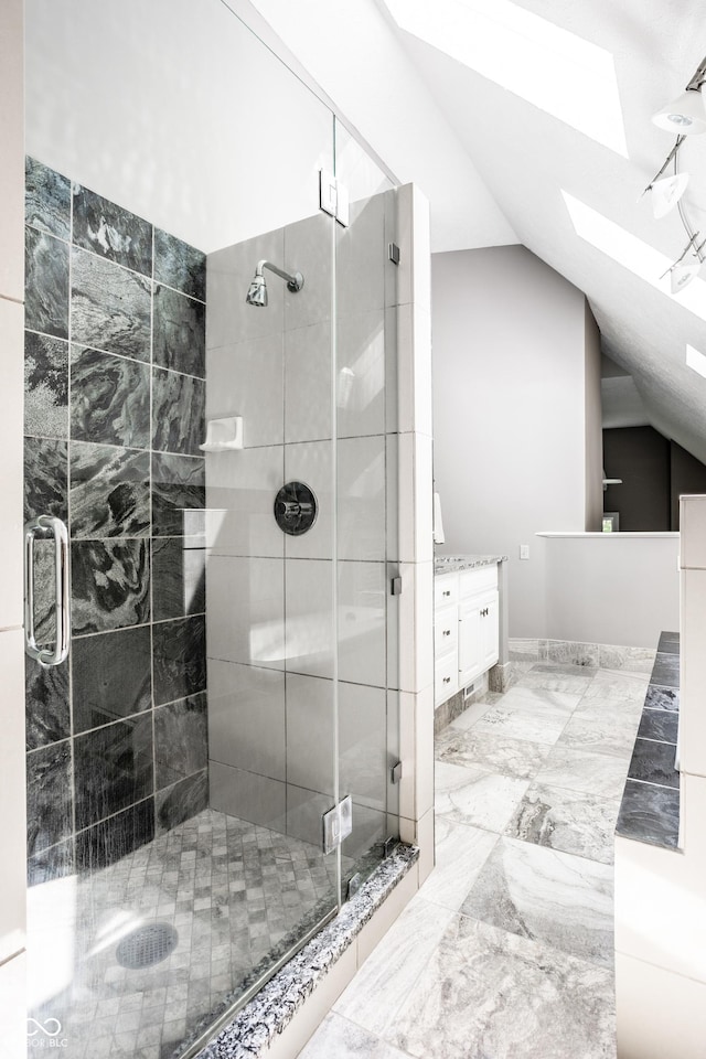 10919 Running Tide Ct, Indianapolis, IN 46236 - bathroom with a skylight, lofted ceiling, a shower stall, vanity, and marble finish flooring