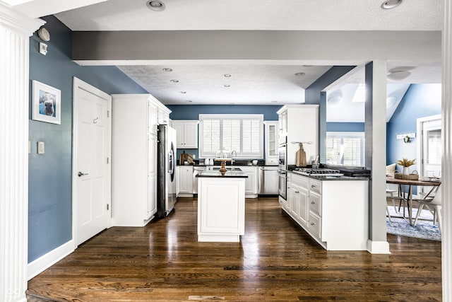 10919 Running Tide Ct, Indianapolis, IN 46236 - kitchen with dark countertops, appliances with stainless steel finishes, plenty of natural light, dark wood-style floors, and a textured ceiling