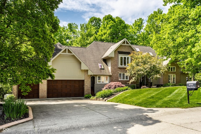 10919 Running Tide Ct, Indianapolis, IN 46236 - view of front of property featuring brick siding, a garage, a front yard, driveway, and a shingled roof