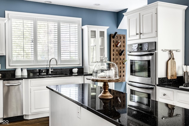 10919 Running Tide Ct, Indianapolis, IN 46236 - kitchen with stainless steel double oven, white cabinets, plenty of natural light, and dark stone countertops