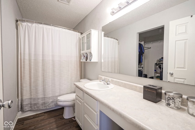 full bath with vanity, wood finished floors, toilet, a textured ceiling, and a shower with curtain