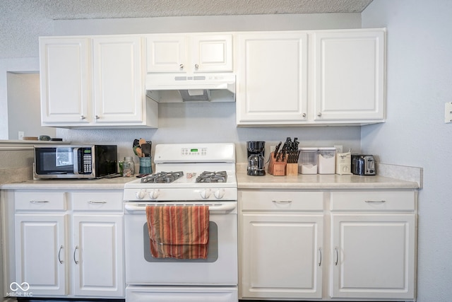 kitchen with under cabinet range hood, stainless steel microwave, white range with gas stovetop, and white cabinets